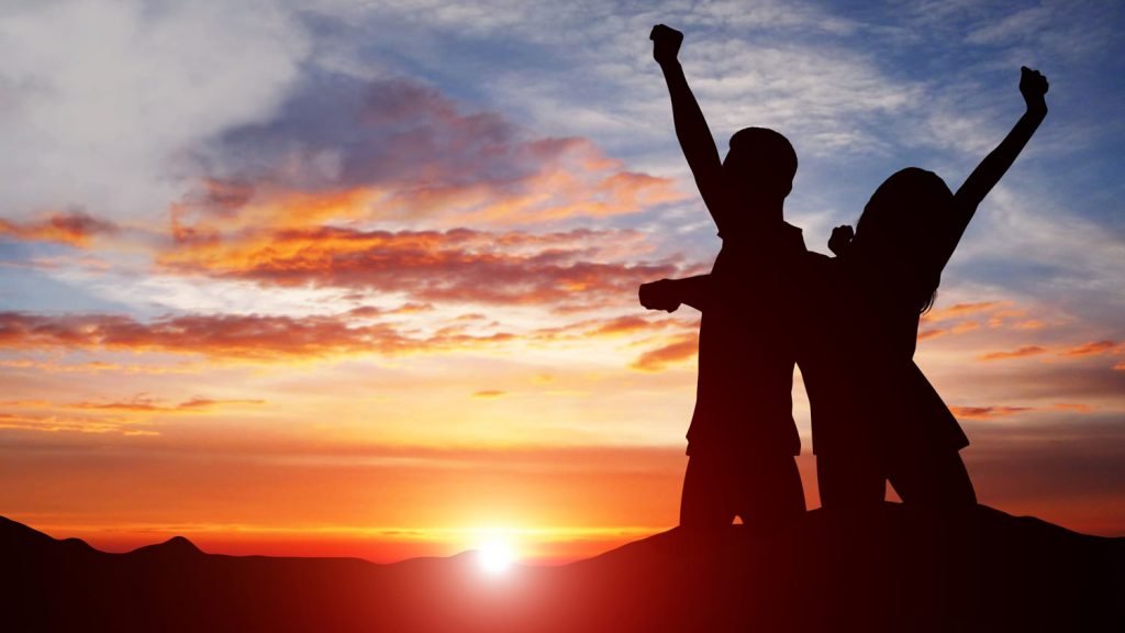 Silhouette Of Couple Celebrating Success Against 4HJG2PY 1024x576